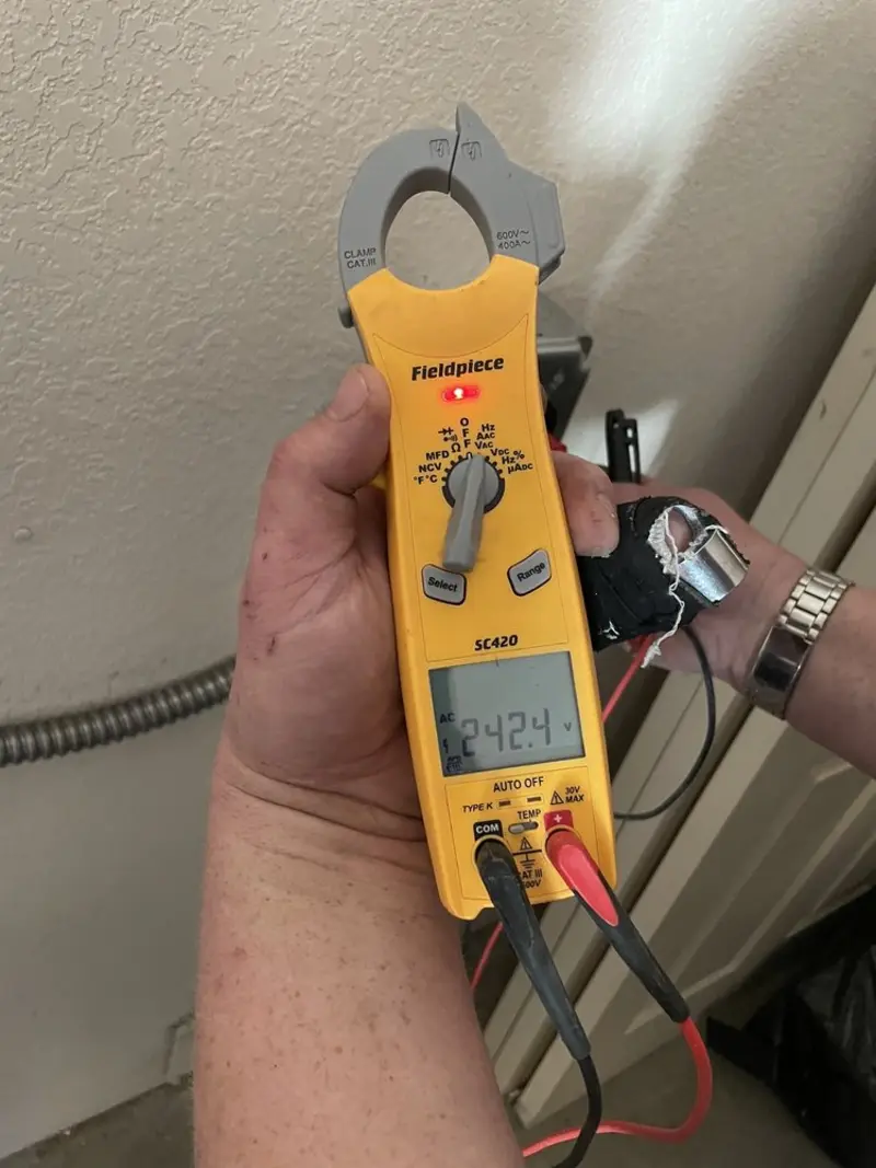 Voltage testing with clamp meter during Outlet Installation in Red Oak